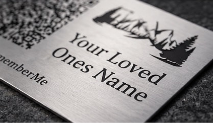 A memorial plaque with roses and a candle